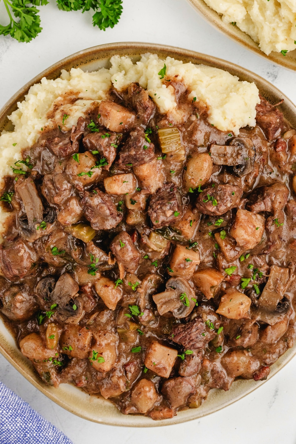 Beef Bourguignon in a bowl Beef Bourguignon on top of mashed potatoes