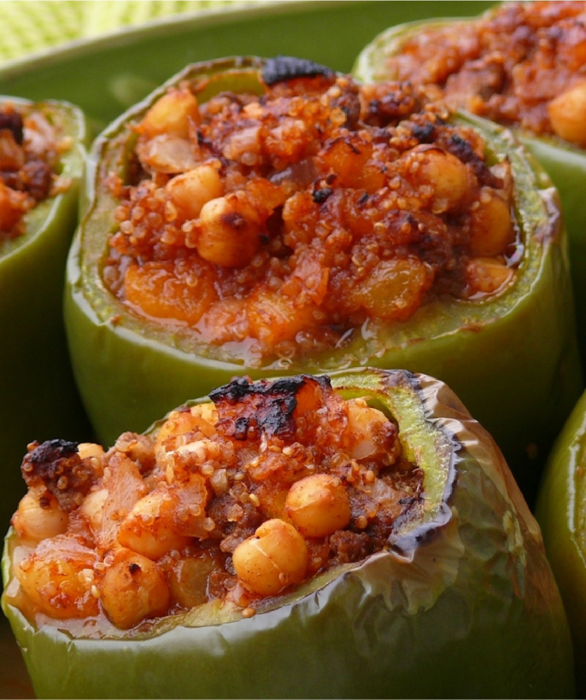 Mediterranean-Style Stuffed Peppers ready to eat Close-up of finished Mediterranean-Style Stuffed Peppers in a baking dish, showing the tender bell peppers filled with spiced beef, quinoa, and chickpeas.