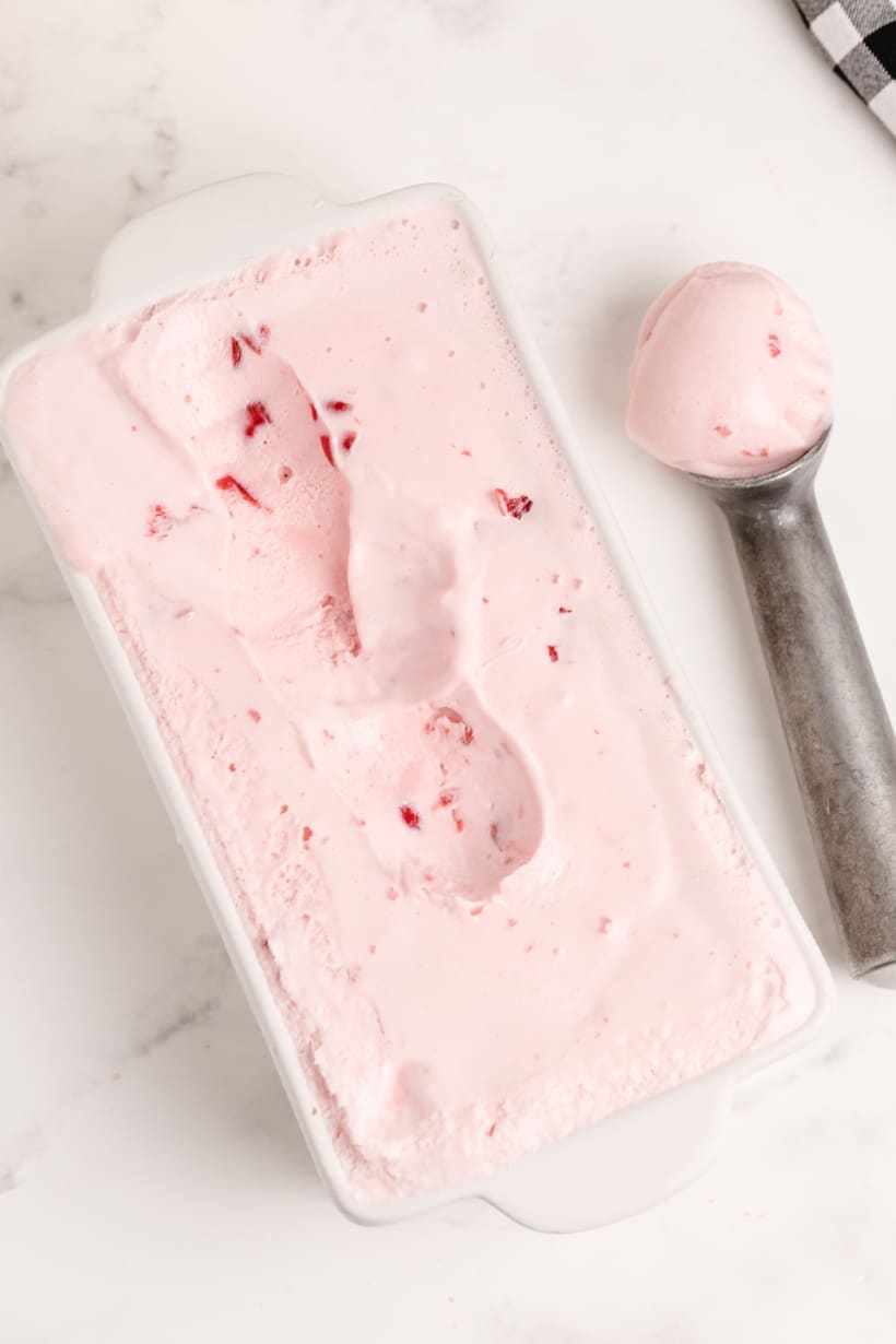 Maraschino Cherry Ice Cream is a deliciously creamy cherry ice cream and does not require making a custard. Just chill your ingredients before freezing in your ice cream maker and you will soon be enjoying your new favorite dessert. maraschino ice cream with a scooper