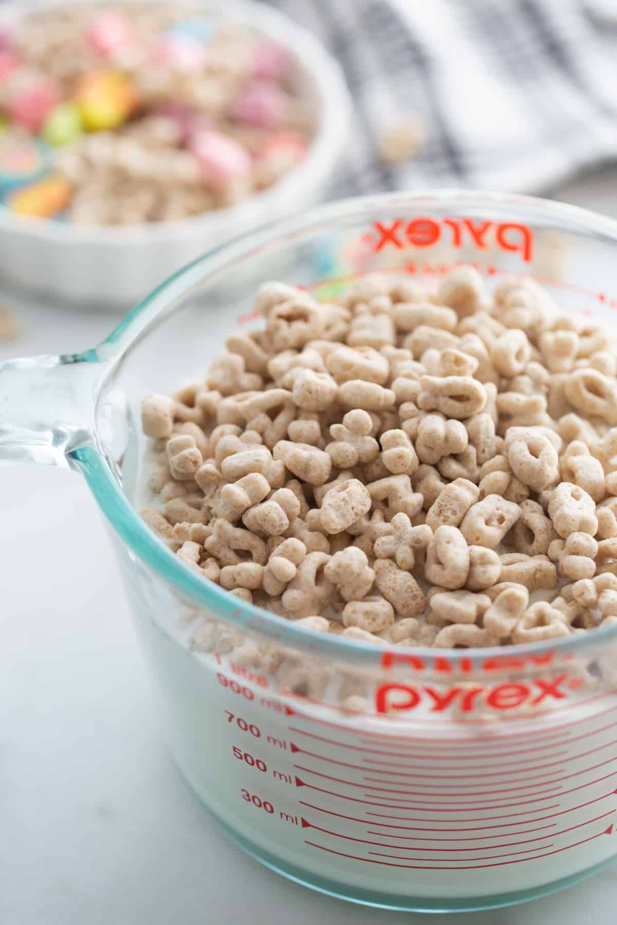 Lucky Charms Ice Cream milk infusion process A bowl of milk and cream with Lucky Charms cereal added, beginning the flavor infusion process.