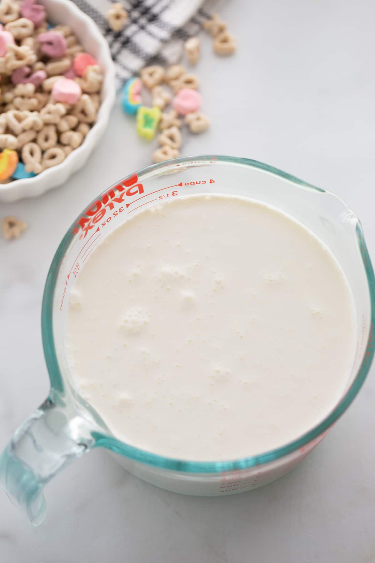 Lucky Charms Ice Cream milk and cream mixture A top-down view of a measuring cup filled with heavy cream and milk, ready for the ice cream base.