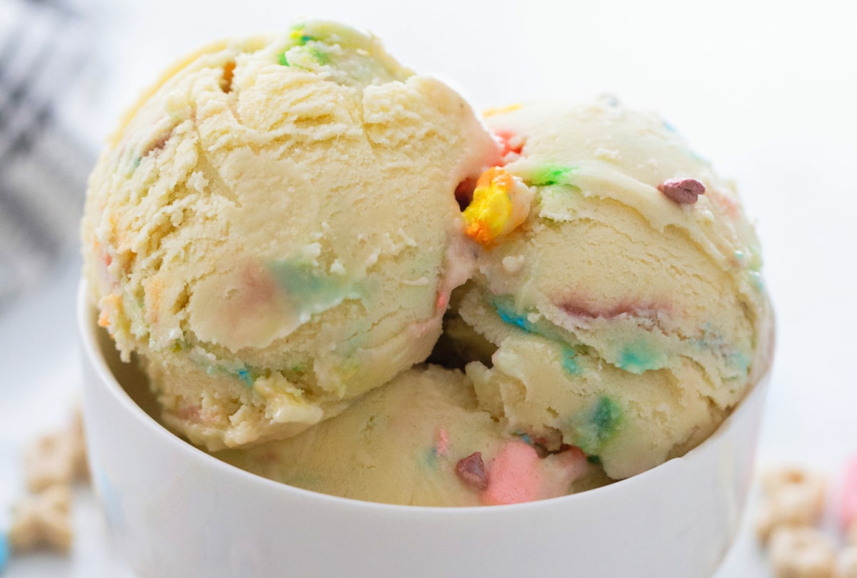 Lucky Charms Ice Cream in a white bowl A bowl with two scoops of Lucky Charms Ice Cream, with bits of cereal and marshmallows visible.