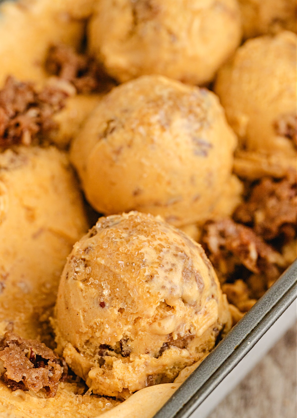 Pumpkin Brown Sugar Crunch Ice Cream with Streusel and Turbinado Sugar Close-up of Pumpkin Brown Sugar Crunch Ice Cream with pecan streusel and turbinado sugar on top, showing creamy pumpkin custard texture and buttery crunch.