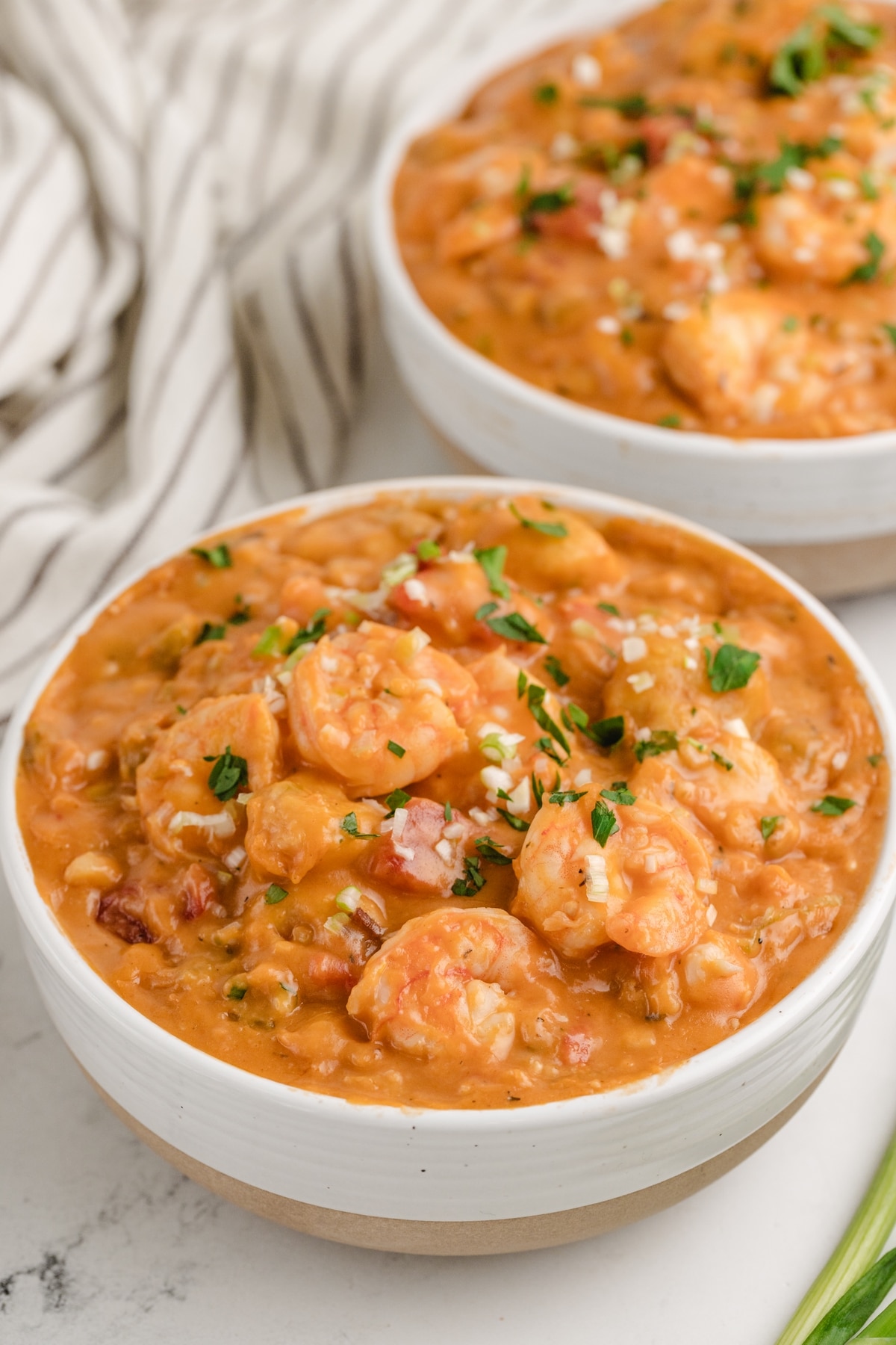 Creamy Shrimp Creole Soup with Bacon-Cornmeal Dumplings in two white bowls