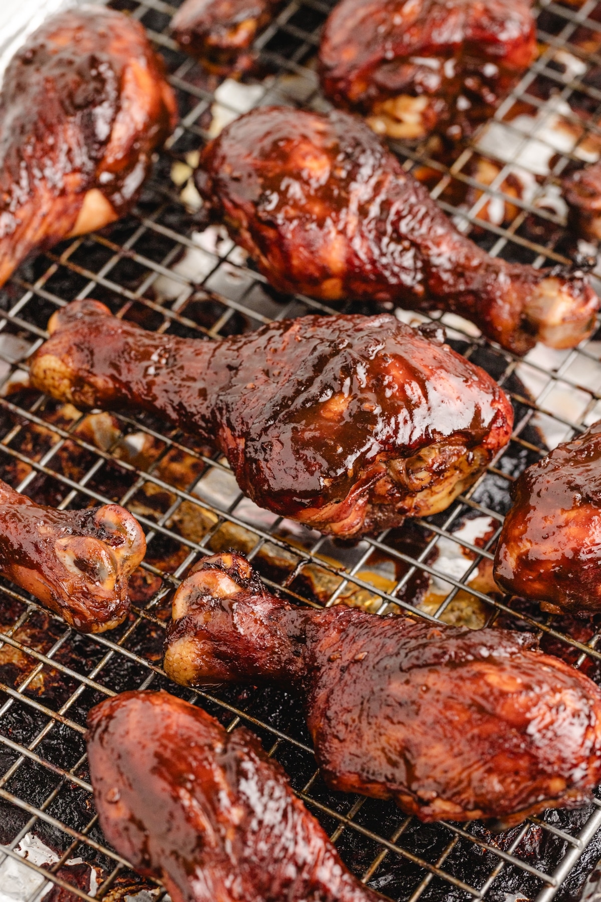 Oven-baked brined chicken drumsticks on a foil-lined rack