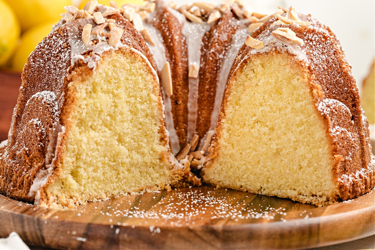 Limoncello Syrup Lemon Bundt Cake with Glaze and Almonds Limoncello Bundt cake sliced open to show soft lemon crumb and almond glaze