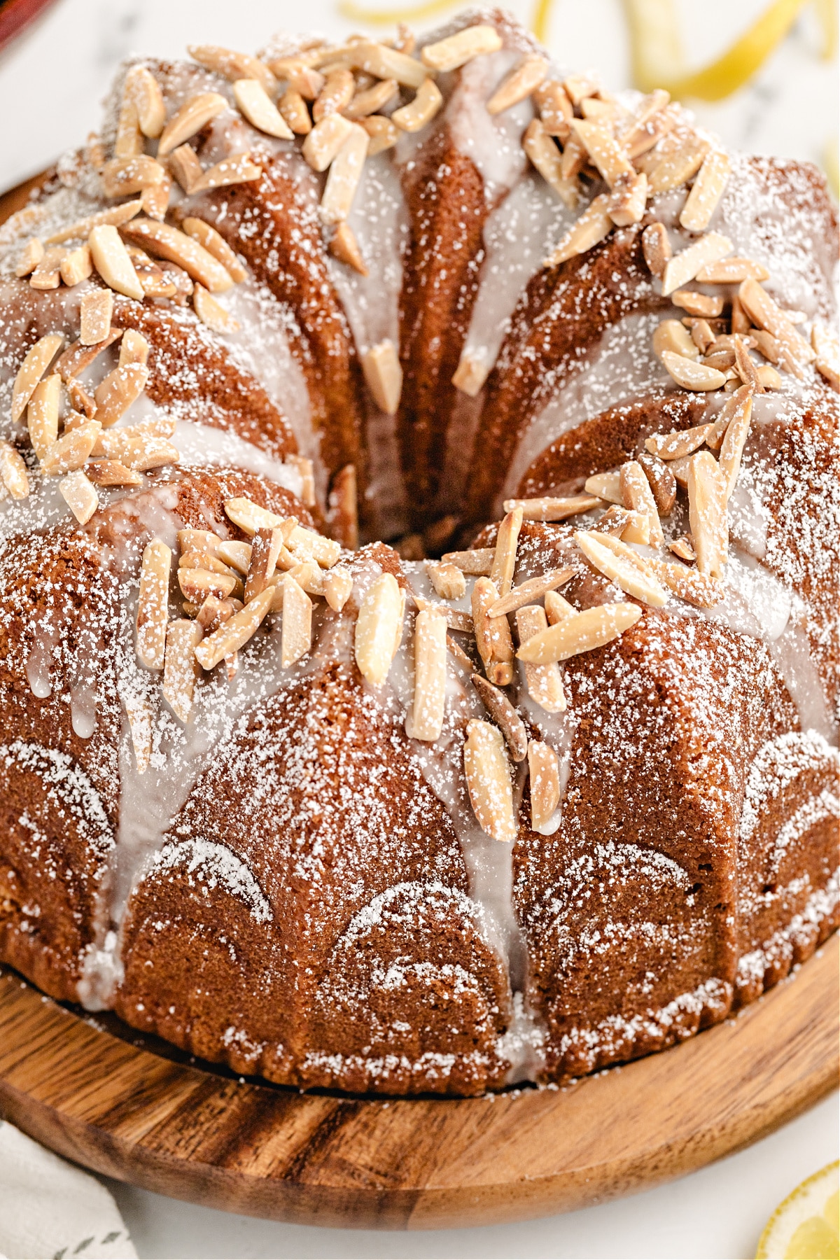 Whole Limoncello Syrup Bundt Cake with Almond Topping Whole lemon Bundt cake with limoncello glaze and slivered almonds