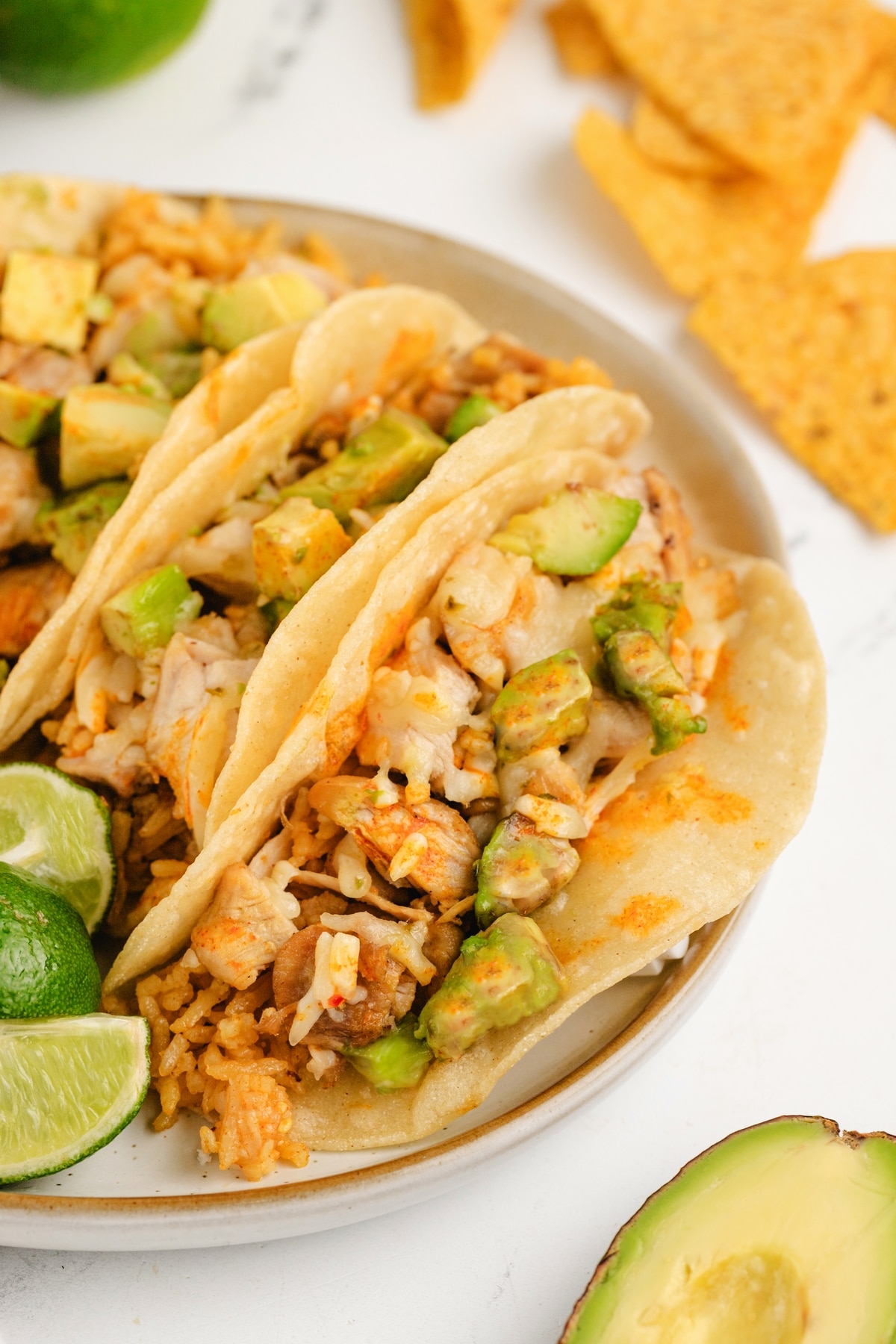 Chicken Paprikash Tacos with avocado A close-up of a Chicken Paprikash Tacos, featuring smoky chicken, melted Pepper Jack cheese, and fresh avocado in a crispy corn tortillas.