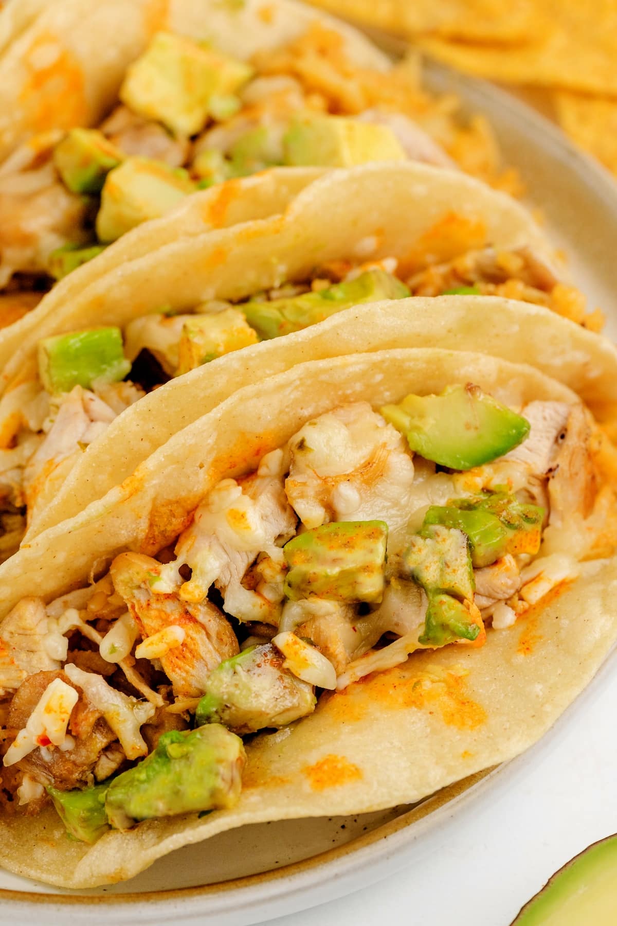 Chicken Paprikash Tacos on a platter A group of Chicken Paprikash Tacos on a platter, showing the layers of smoky chicken, avocado, and cheese.