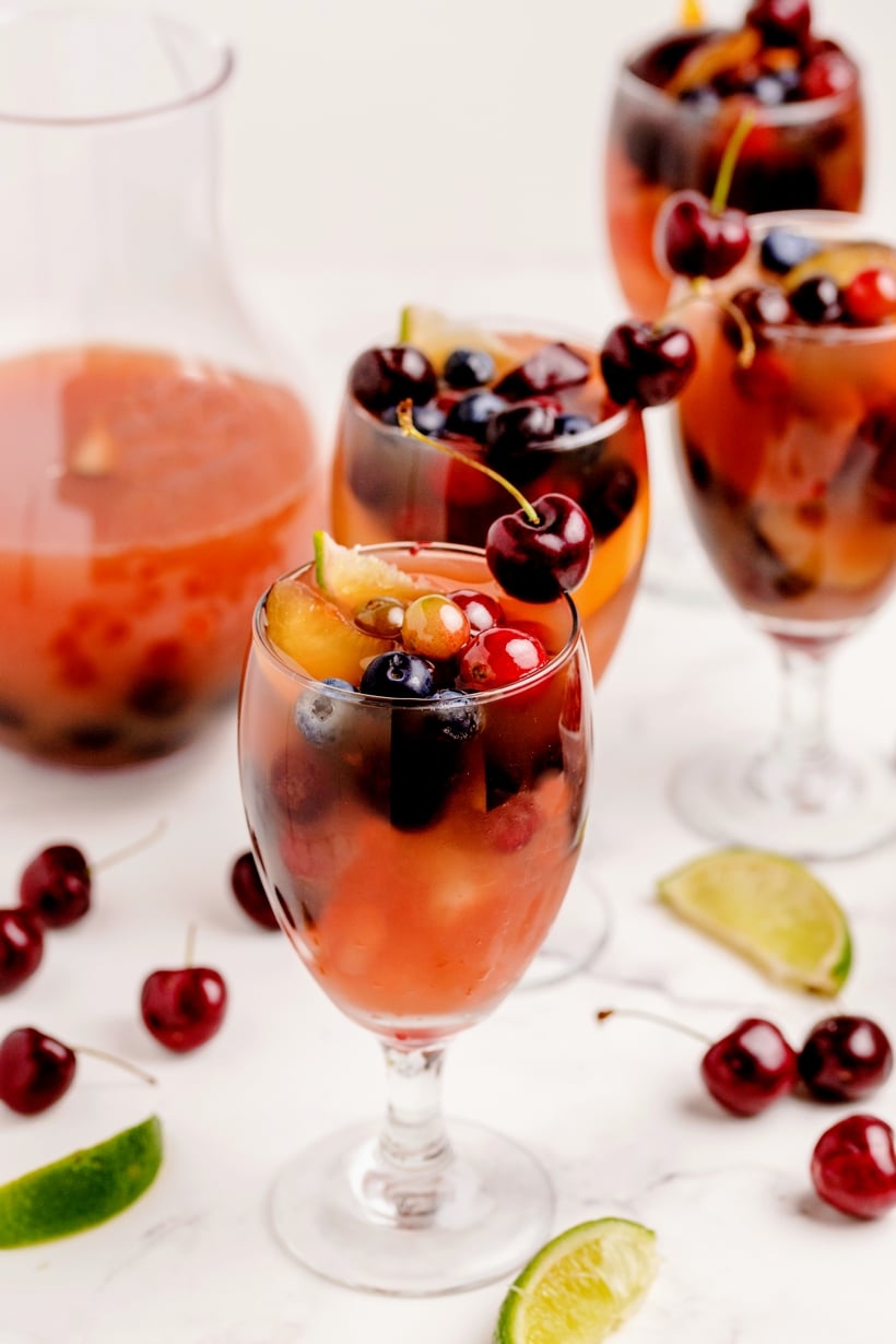 Enjoy the abundance of cherry season with a favorite cherry sangria recipe. Fresh cherries, oranges and grapes make this sangria look as amazing as it tastes. cherry orange sangria
