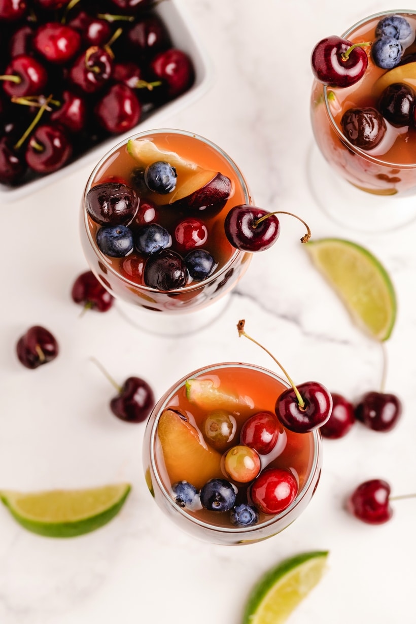 Enjoy the abundance of cherry season with a favorite cherry sangria recipe. Fresh cherries, oranges and grapes make this sangria look as amazing as it tastes. red sangria with cherries