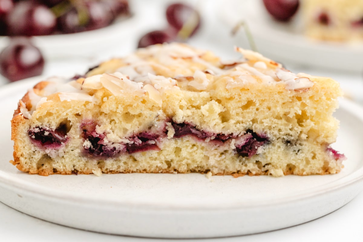 Slice of Sour Cream Cherry Almond Coffee Cake Slice of cherry almond coffee cake on a plate