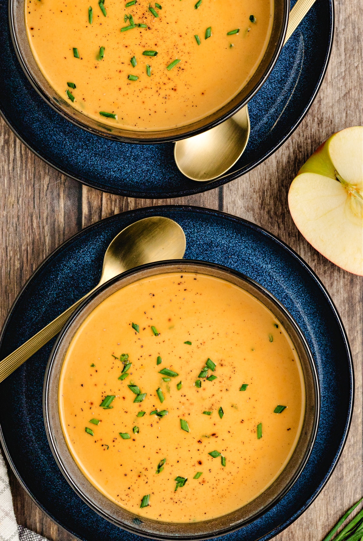 Maple butternut squash soup recipe Maple Butternut Squash and Apple Soup with chives in dark bowls
