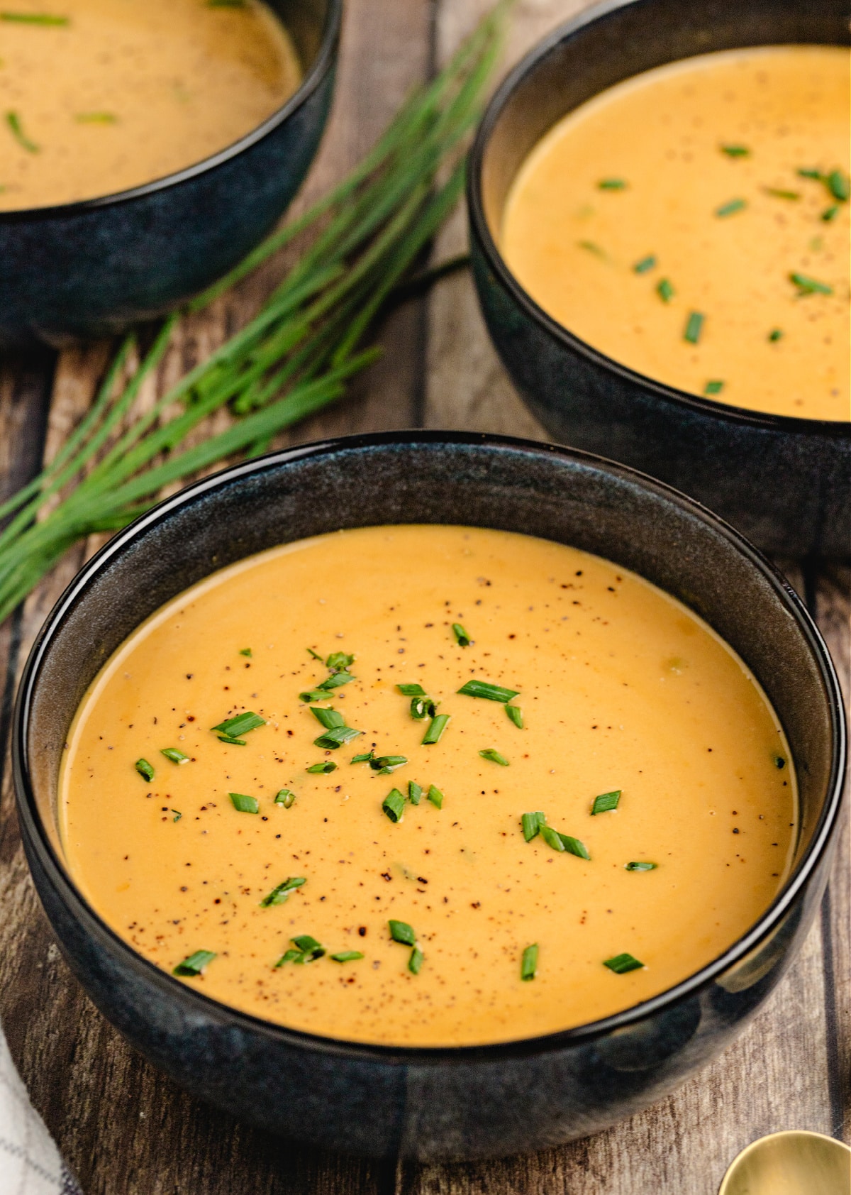 Creamy butternut squash soup with apple Creamy butternut squash and apple soup topped with fresh chives