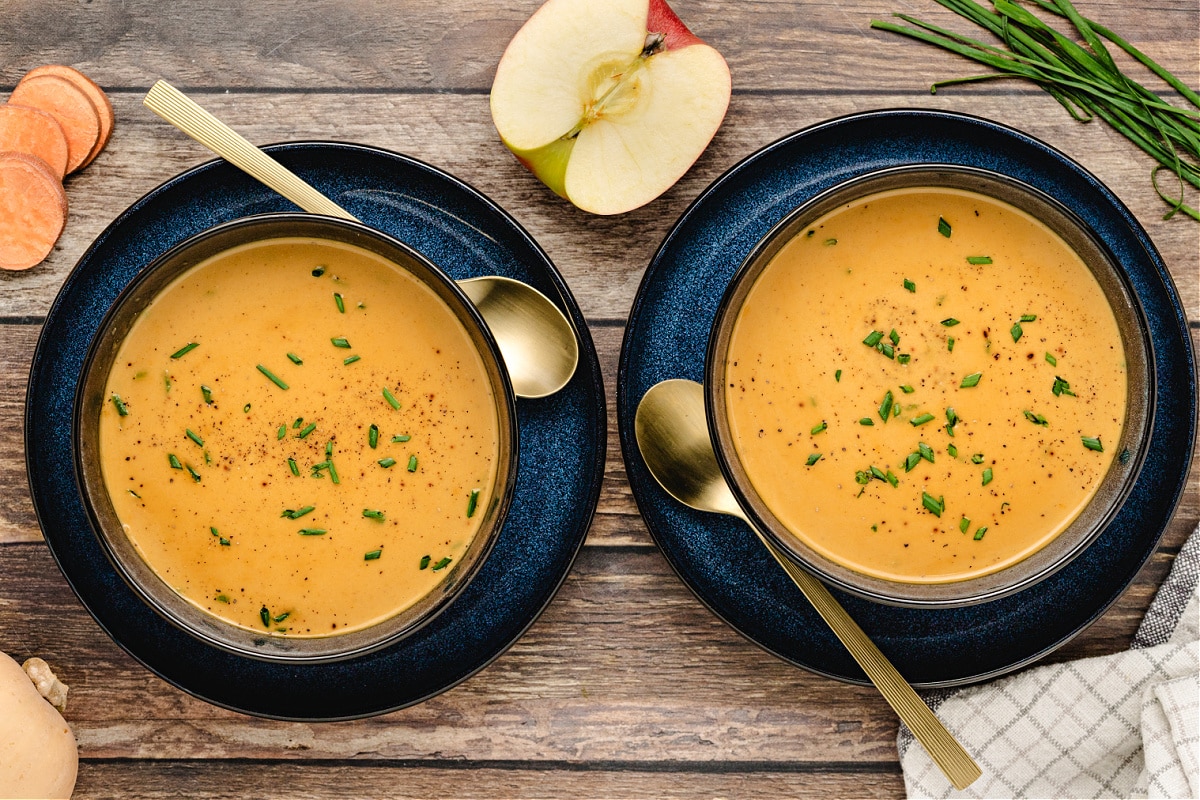 Maple butternut squash apple soup Maple butternut squash soup served with apple and sweet potato on the side