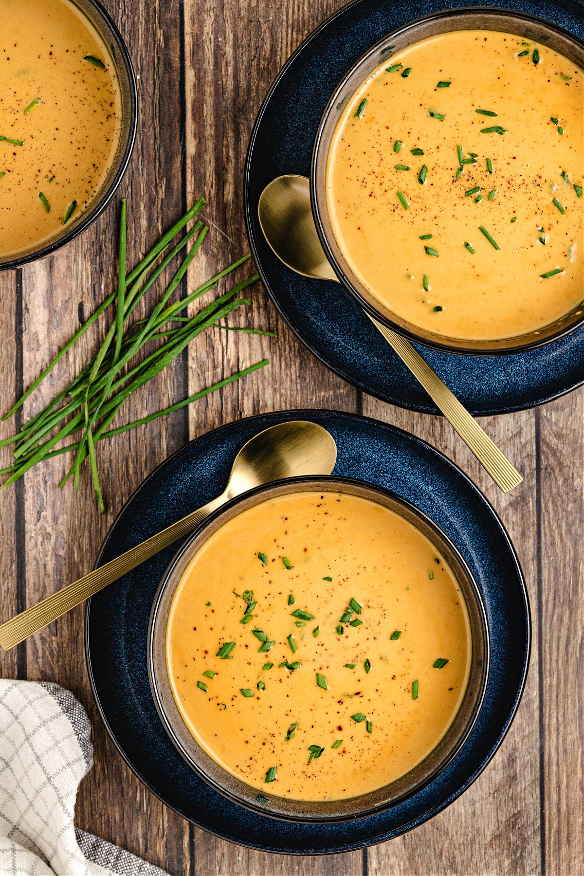 Maple butternut squash and apple soup Maple Butternut Squash and Apple Soup in dark bowls on wood table