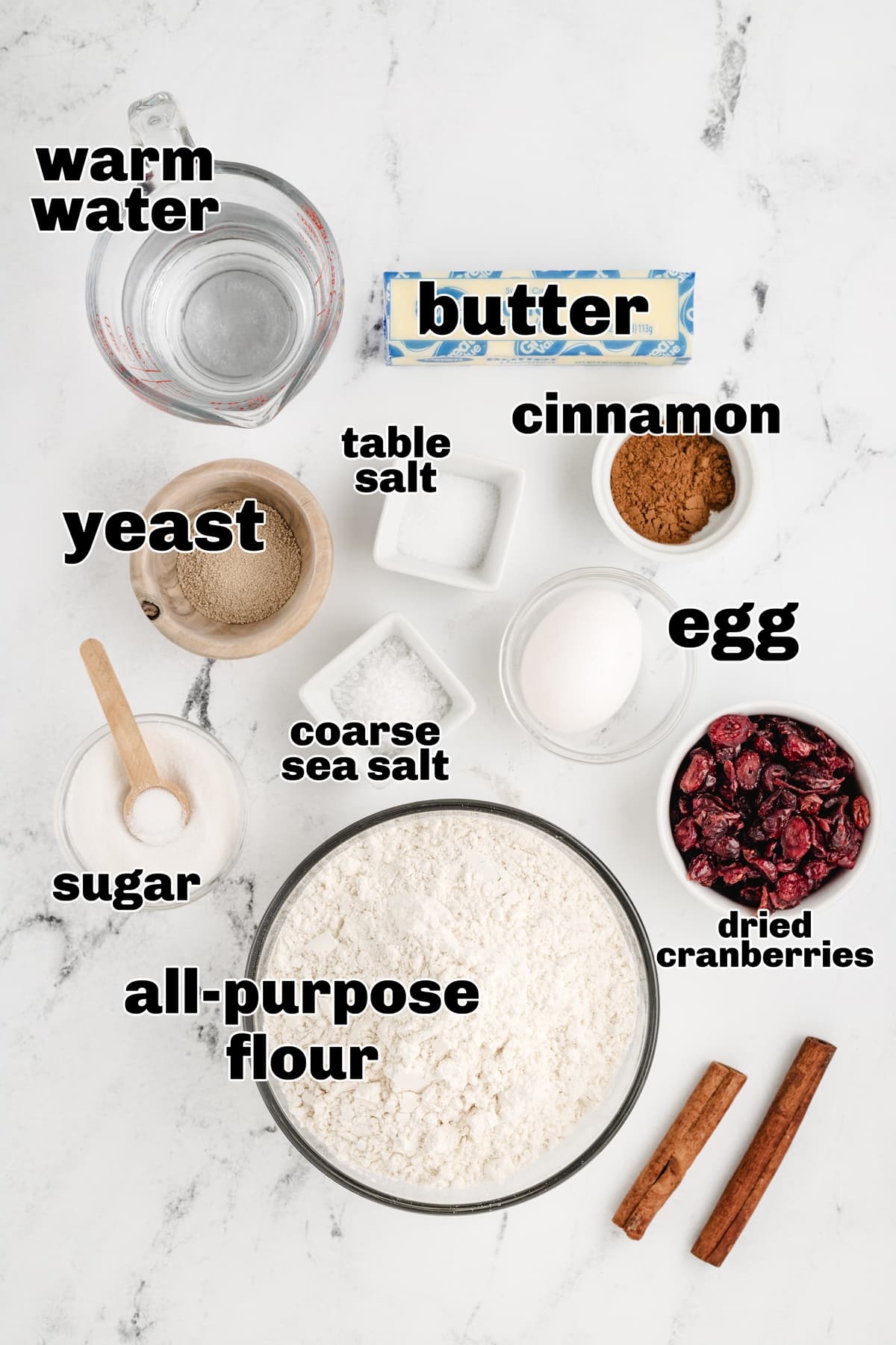 Ingredients for cinnamon-cranberry dinner rolls recipe. Ingredients for cinnamon-cranberry dinner rolls, including flour, sugar, yeast, cinnamon, salt, butter, and dried cranberries.