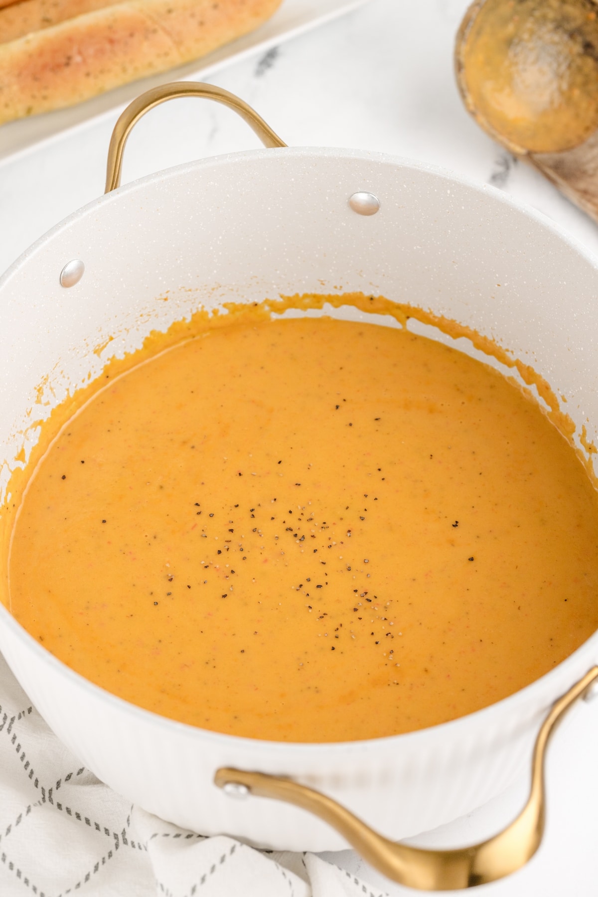 Creamy Red Pepper Coconut Soup Rich and creamy red pepper coconut soup in a large pot.