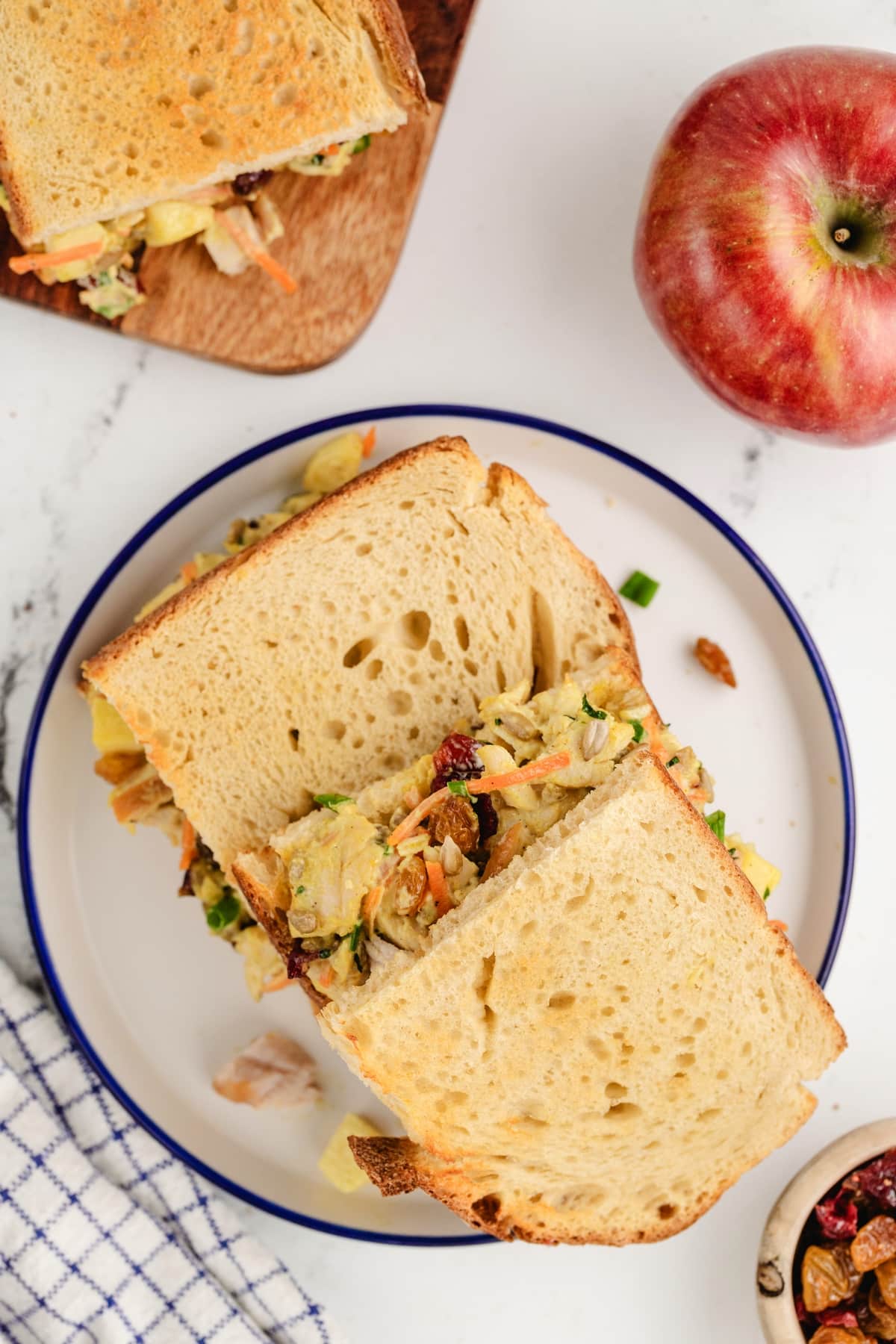 Curried Turkey Salad on a white plate. overhead view of turkey salad with bread.