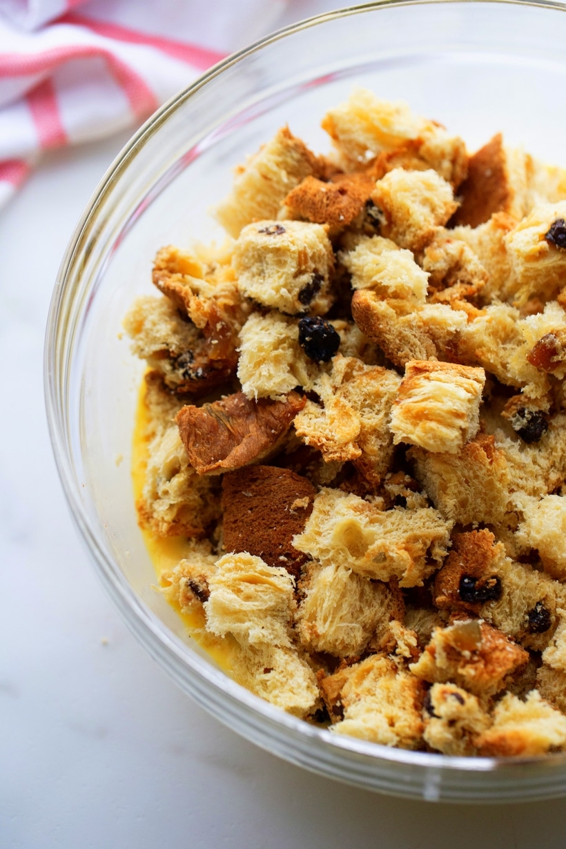 Panettone chunks soaking in eggnog mixture for French toast casserole.