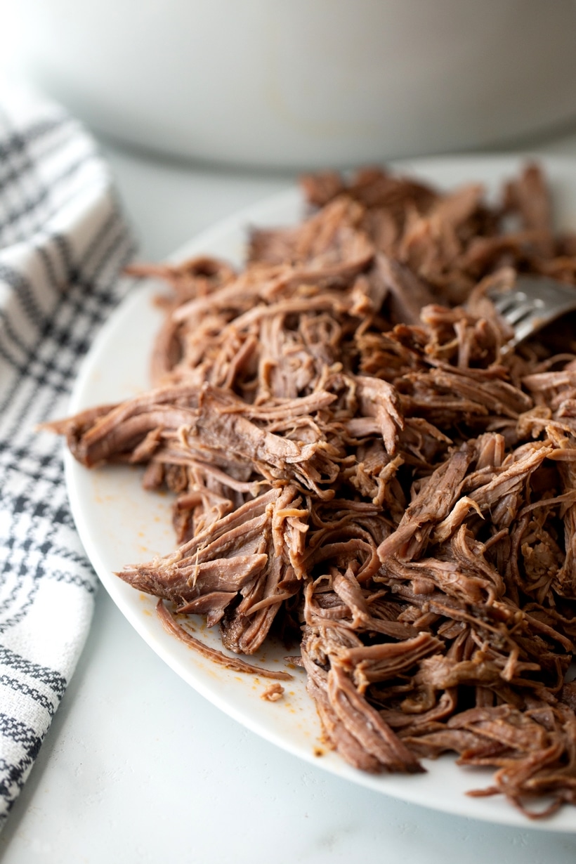 crockpot chili colorado with shredded chuck roast on a platter