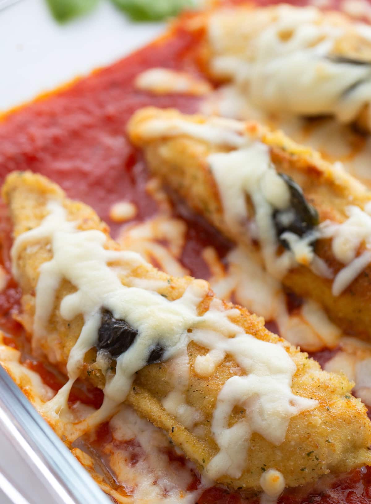 Baked chicken tenderloin marinara dish Chicken tenderloins fresh out of the oven with bubbly cheese and marinara
