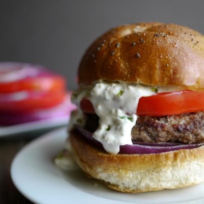 The burger itself sitting on a white plate.