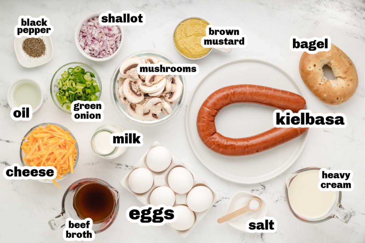 Ingredients for bagel breakfast casserole with kielbasa, bagels, eggs, and cheese.
