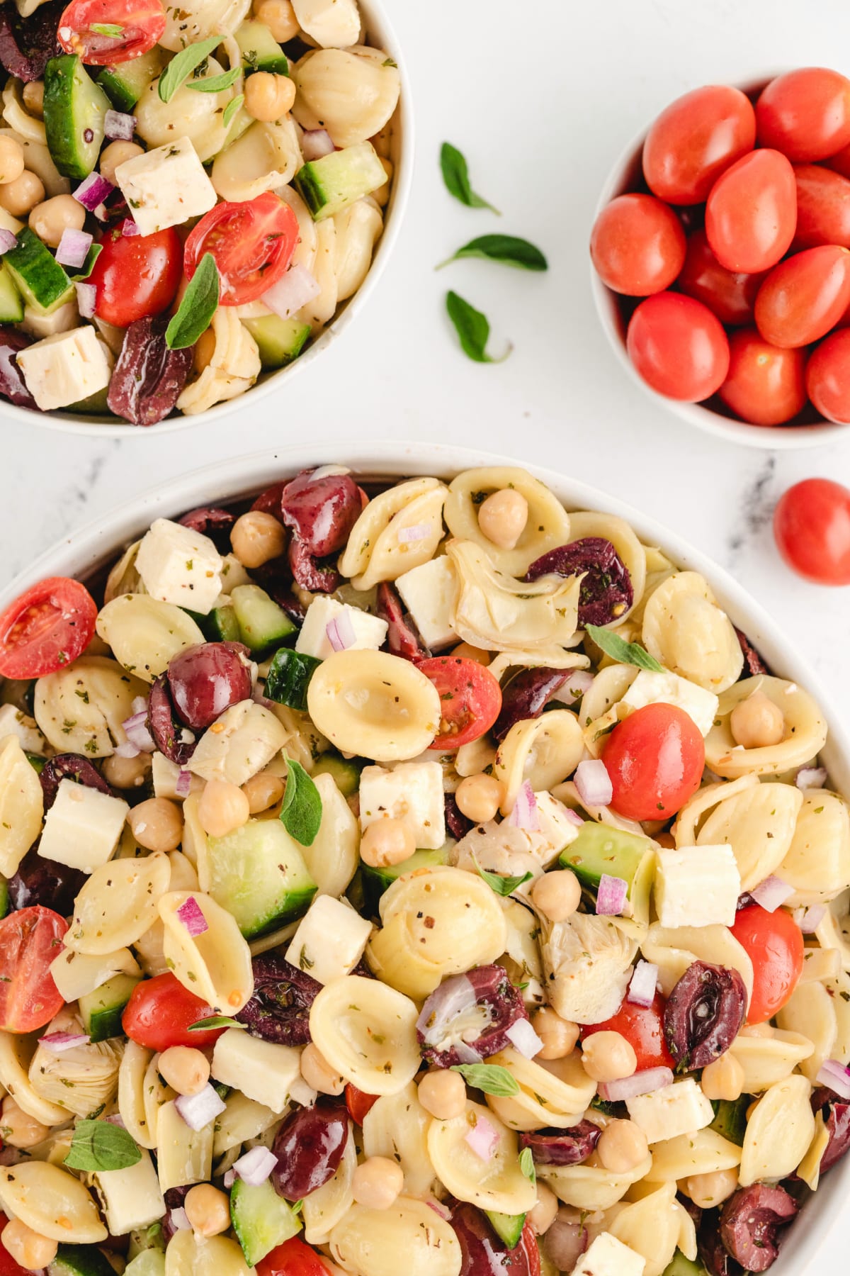 Greek Pasta Salad top view A portion of Greek pasta salad served on a plate with a fork, highlighting the colorful ingredients.