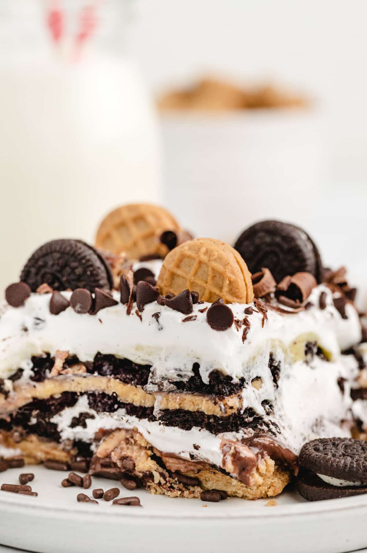 Detailed view of Oreo and Nutter Butter icebox cake layers with whipped topping Close-up of layered peanut butter and chocolate no-bake cake with cookies and pudding