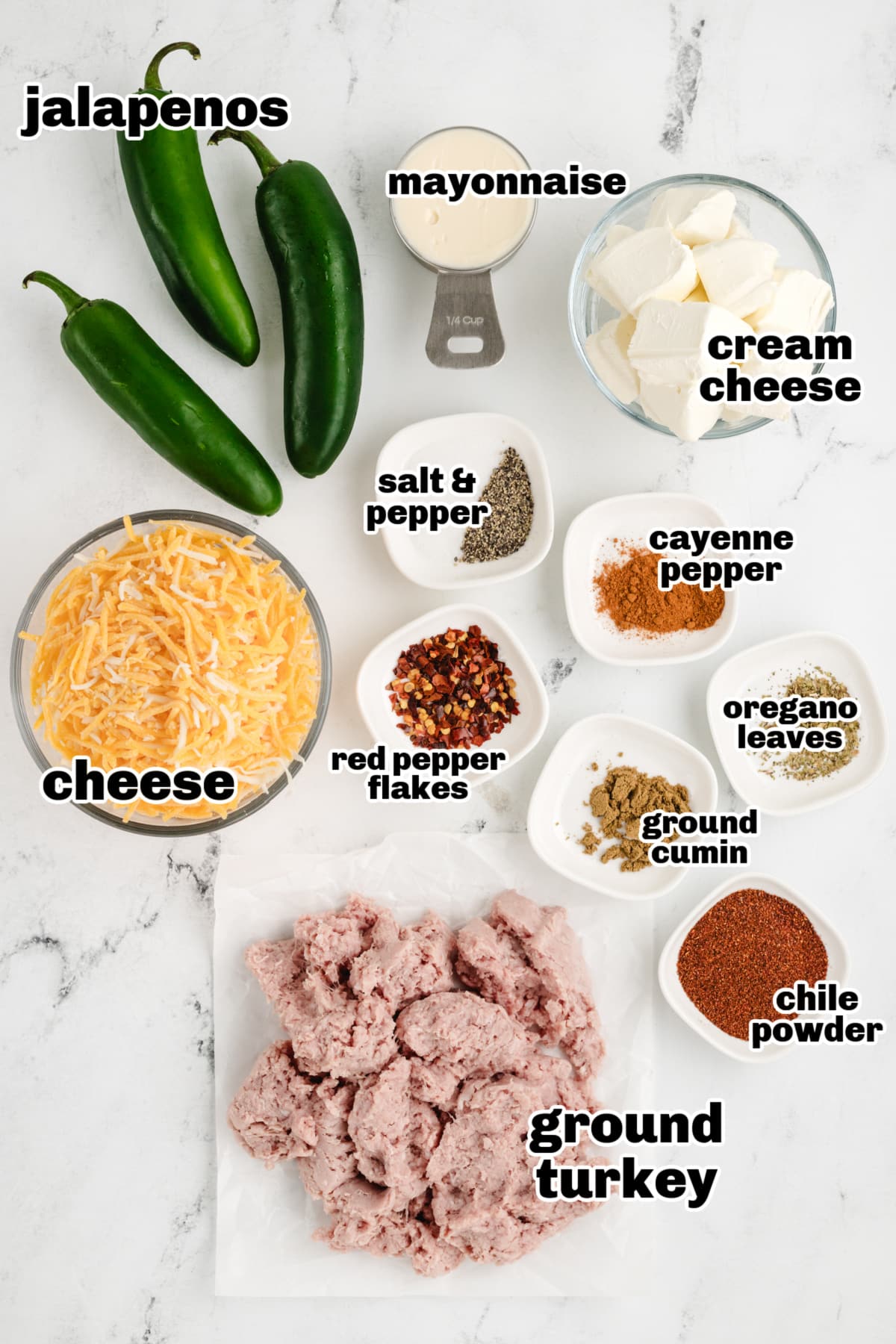 Ground Turkey Stuffed Jalapenos Overhead shot of ingredients, including jalapeños, ground turkey, shredded cheese, and spices, laid out before preparation.