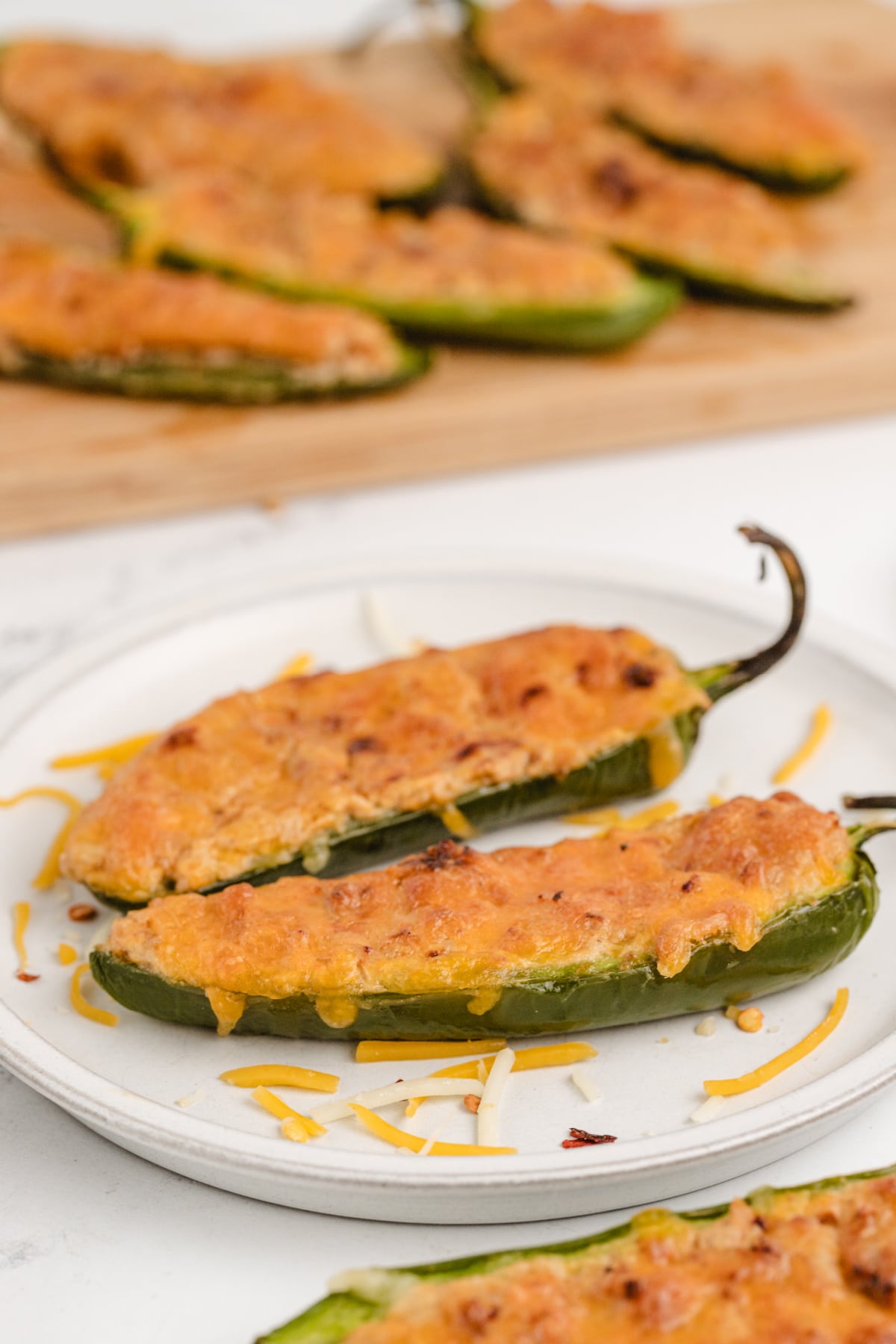 Ground Turkey Stuffed Jalapenos Ground turkey stuffed jalapeños on a plate with a crispy, bubbly cheese topping.