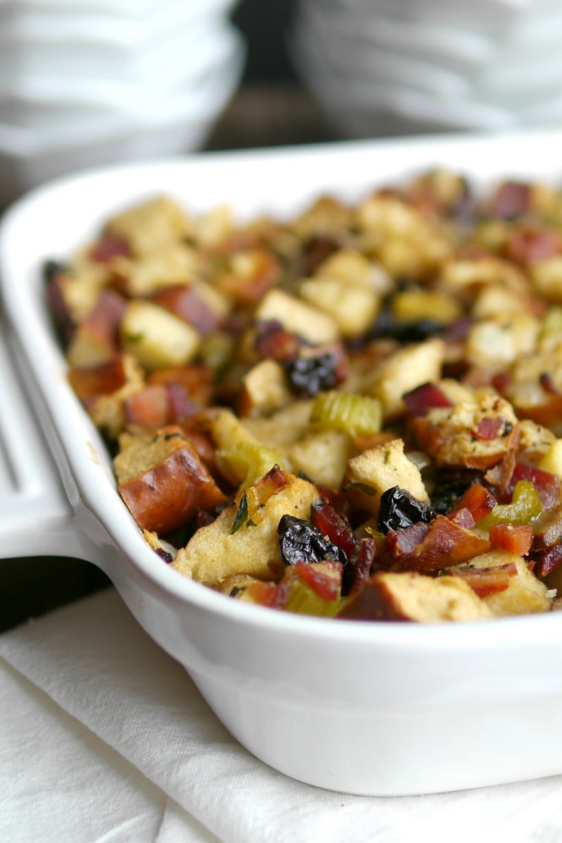 Golden-brown pretzel bread stuffing in a white baking dish