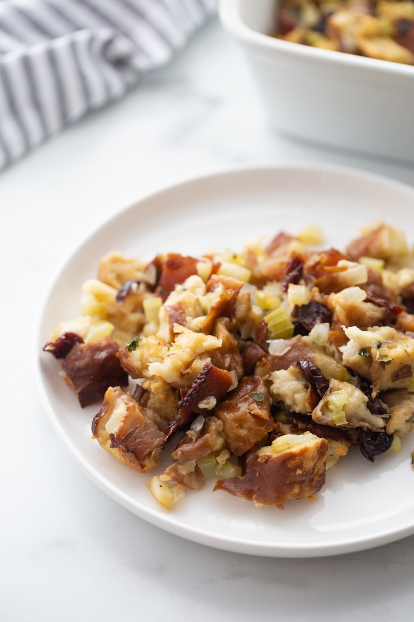Serving of pretzel bread stuffing on a white plate.
