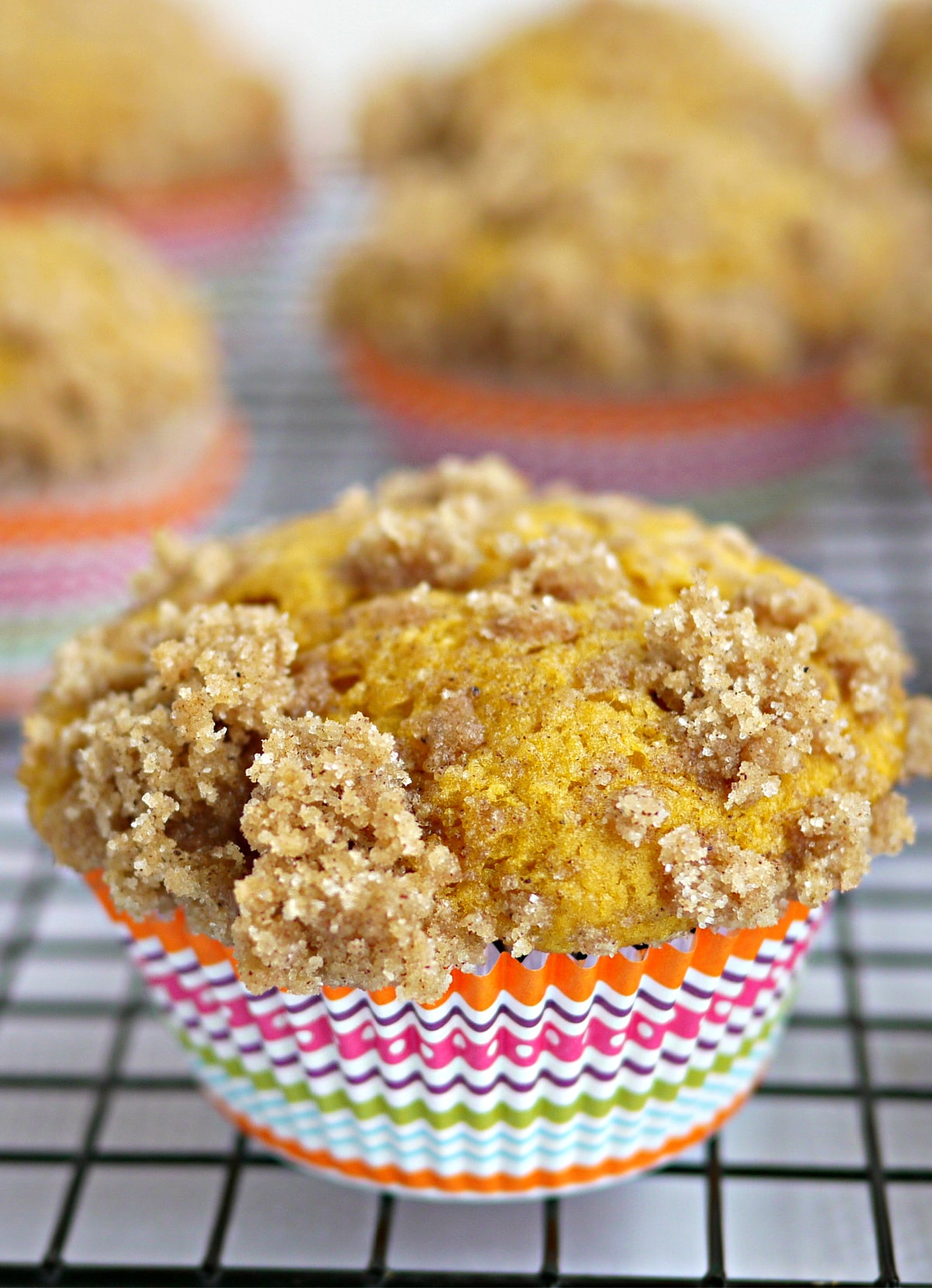 pumpkin muffins with buttermilk cooling on rack pumpkin muffins with buttermilk cooling on a wire rack in colorful liners