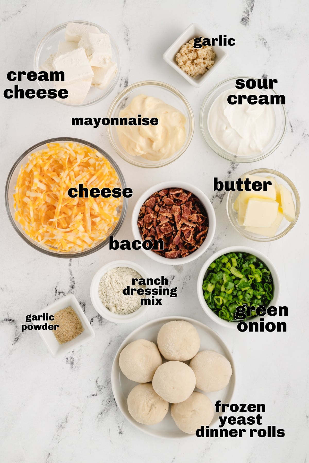 Ingredients for Sour Cream Bacon Ranch Ring Dip Ingredients for sour cream bacon ranch ring dip: cream cheese, sour cream, mayonnaise, shredded Colby Jack cheese, cooked bacon, green onions, garlic, ranch seasoning, and frozen dinner rolls.