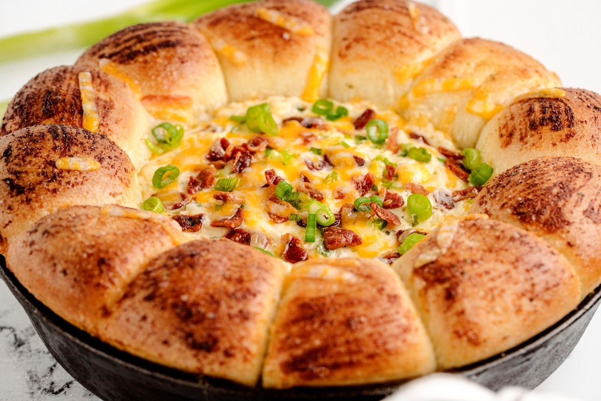 Bacon Ranch Ring Dip Sour cream bacon ranch ring dip served in a cast iron skillet