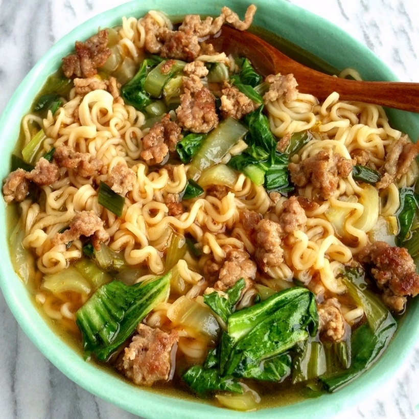 Pork ramen in a green bowl.