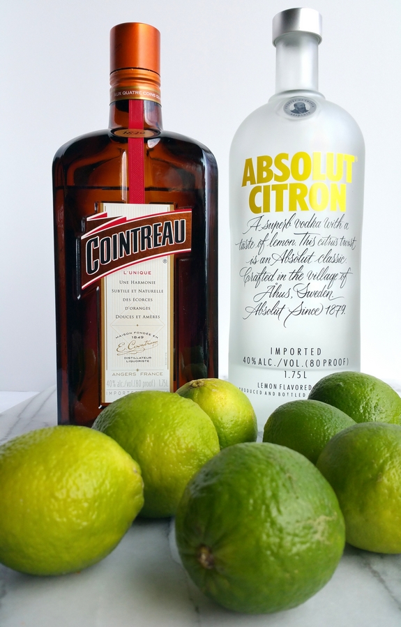 Why would you want to drink anything other than the World's Best Cosmopolitan Cocktail? The only thing girly about this cosmo drink is its color. Bottle of Cointreau and Absolut Citron vodka with limes.