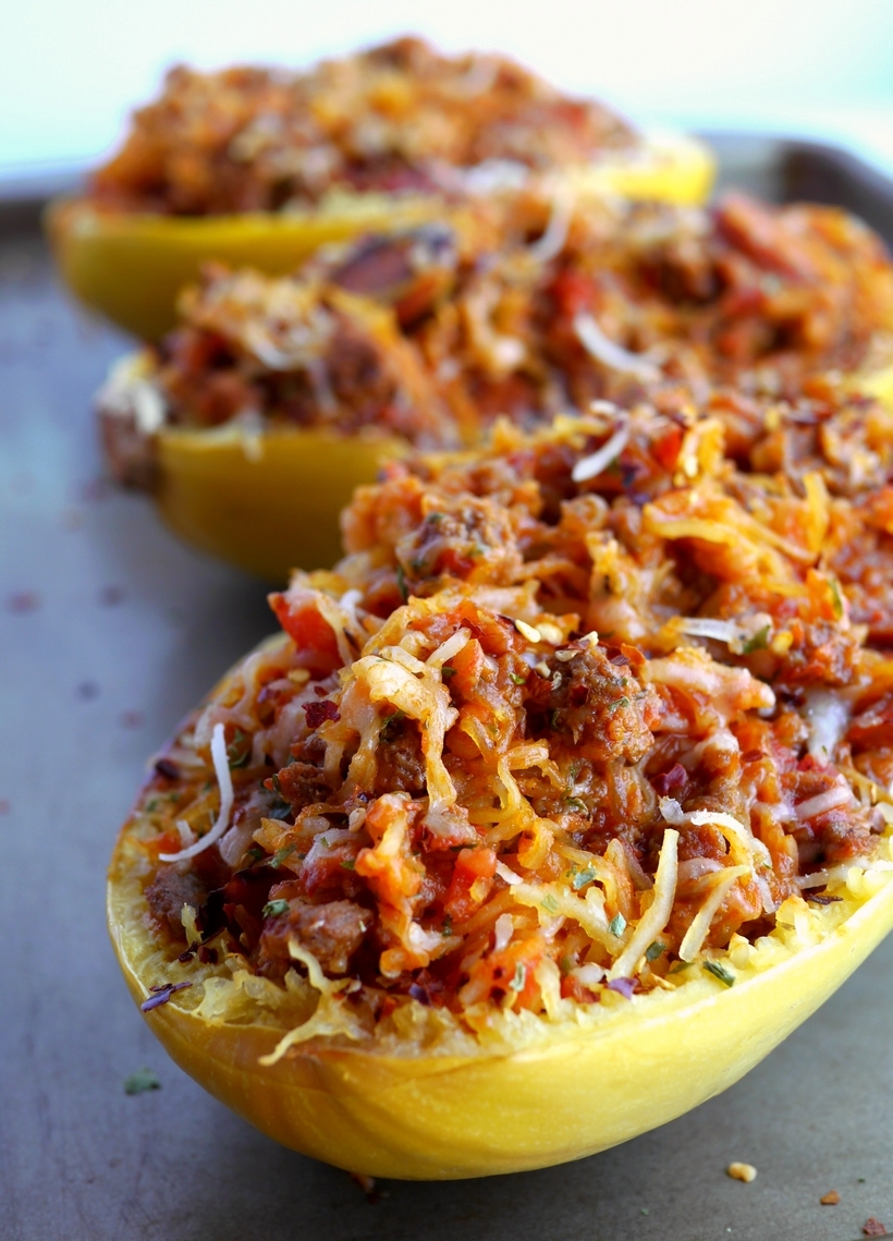 Stuffed Spicy Italian Spaghetti Squash Boats ~ All the flavors of a hearty spaghetti dinner packed into a tender, roasted spaghetti squash. These Stuffed Spicy Italian Spaghetti Squash Boats are the answer to comfort food made in a healthy way.  A fork is all it takes to separate the pale orange strands of the gourd into vegetable noodles. It couldn't be easier from NoblePig.com. #noblepig #spaghettisquash #italianfood #healthyeats