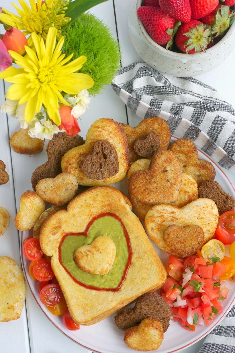 Let Mom sleep in and then wake up to a delicious, restaurant-quality, avocado style, Mother's Day breakfast in bed. If your Mom is anything like me, she will appreciate those extra winks and a thoughtful meal that pays homage to her love of avocados, with a surprise egg underneath. This gorgeous breakfast plate is easy enough for children of all ages to help prepare from NoblePig.com. #noblepig #mothersday #avocado #breakfastinbed #avocadotoast #simplyavocado #whollyguacamole