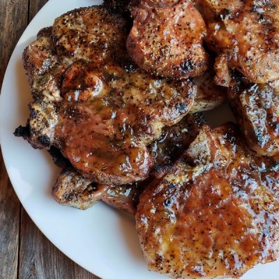 Pork chops on a white platter.