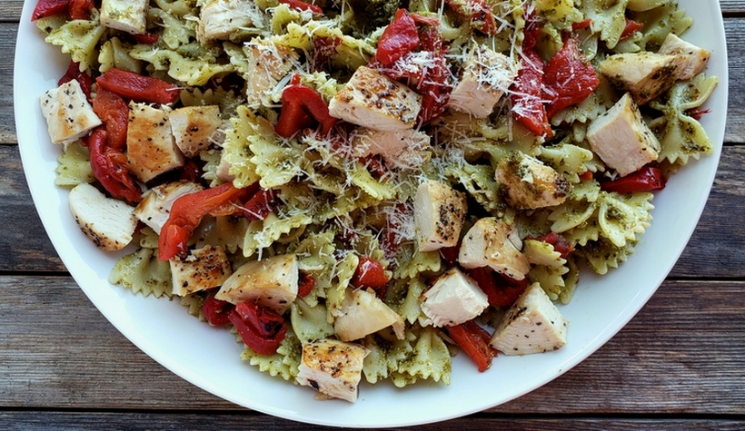 Get dinner on the table with this Quick Chicken and Pesto Pasta. It's full of flavor and makes great leftovers for lunch. bowtie pasta in a bowl with pesto