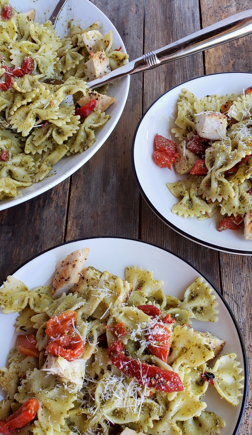 Get dinner on the table with this Quick Chicken and Pesto Pasta. It's full of flavor and makes great leftovers for lunch. Three separate bowls of chicken pesto pasta.