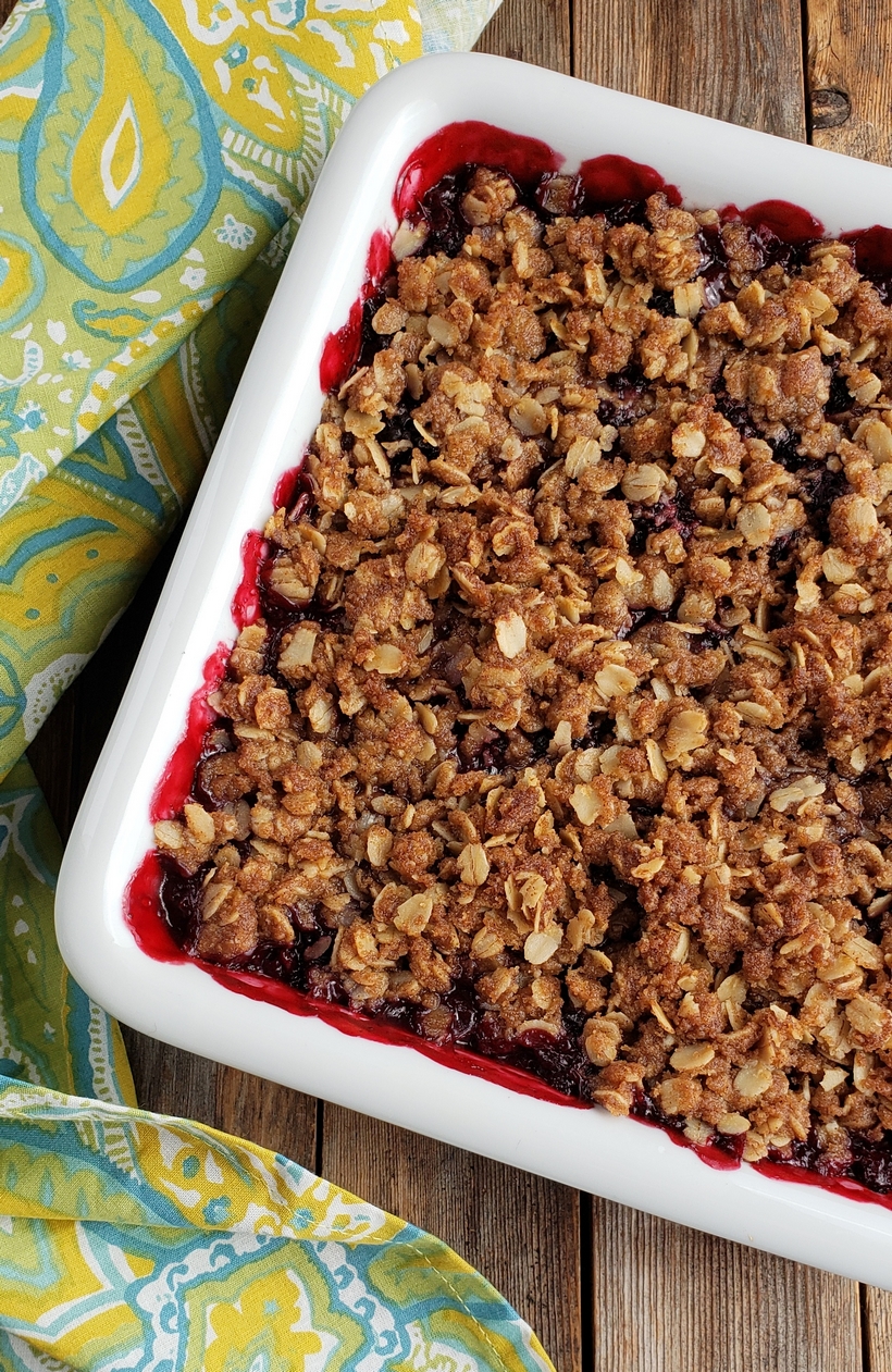 Nothing tastes more like late summer than a Blackberry Crumble. Even if you've never baked from scratch, you will find this recipe so easy to put together. #noblepig #blackberry #crumble #summerdessert Baked blackberry crumble in a serving dish.