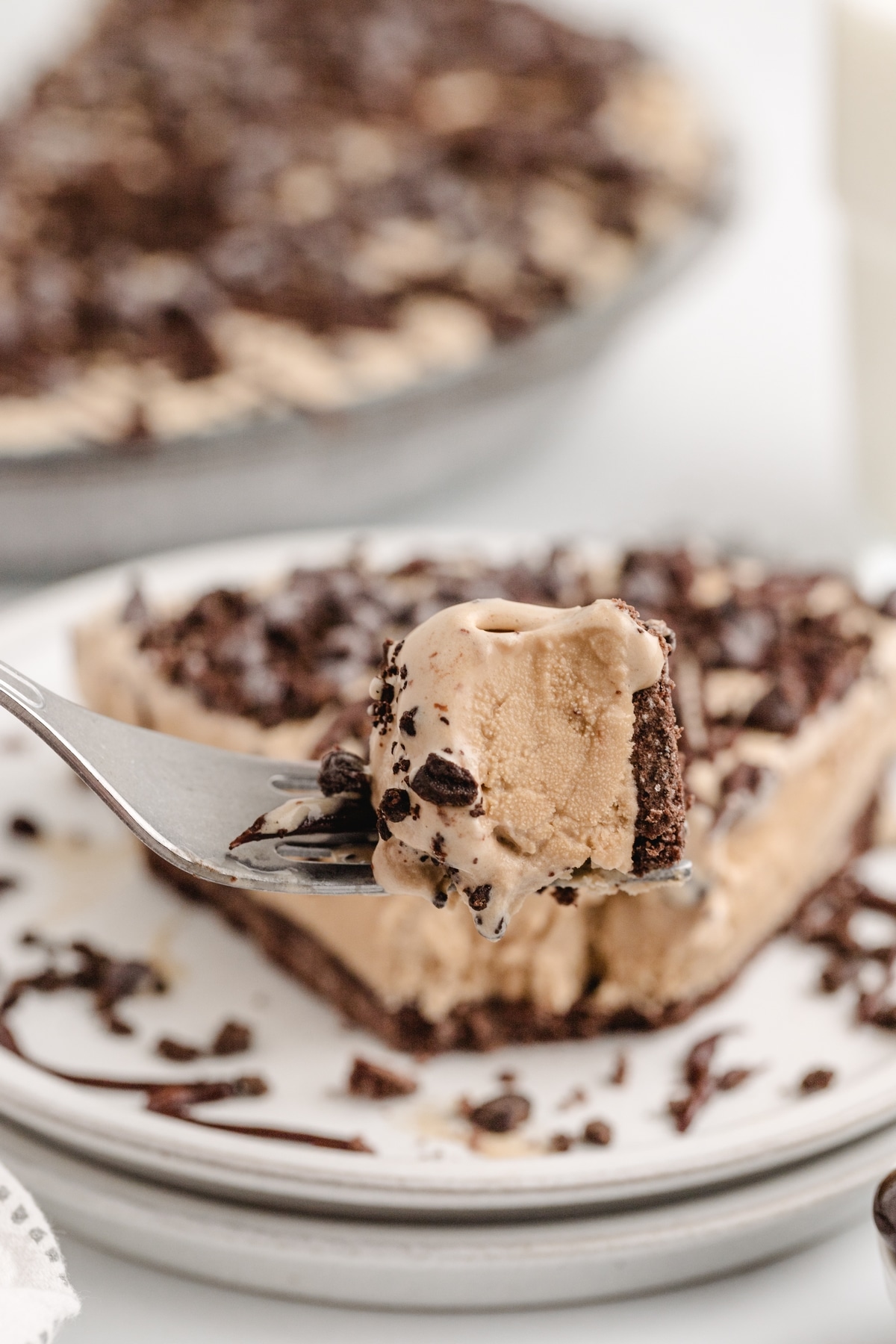 This Mud Pie is a real treat! Coffee-flavored ice cream and chocolate come together for a fantastic combo in every bite. I like to crush up some chocolate-covered espresso beans on top for an extra burst of flavor and a nice crunch. Mud Pie with coffee ice cream