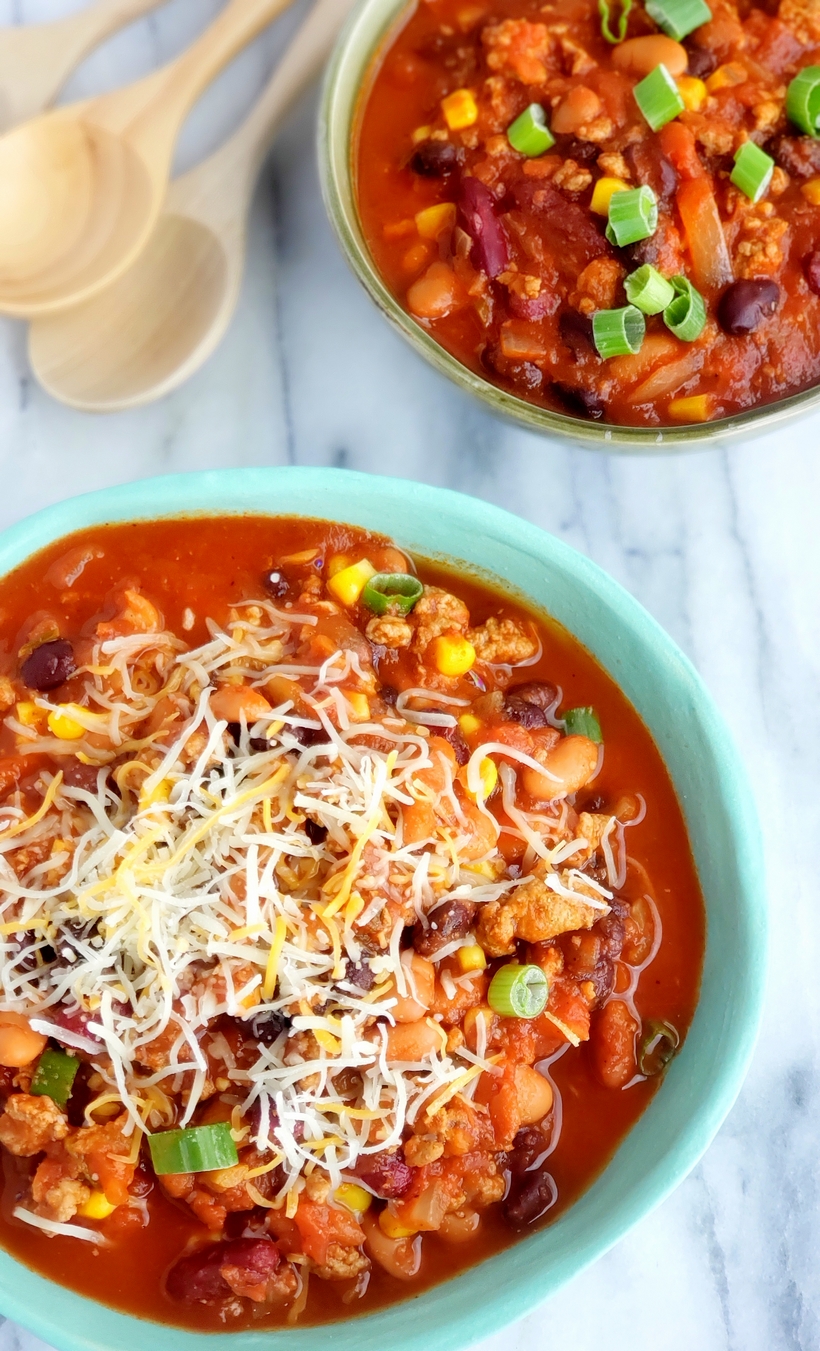 This Low Calorie Turkey Chili is so jammed with flavor, you'll forget you are eating something healthy. Low Calorie Turkey Chili in two bowls.