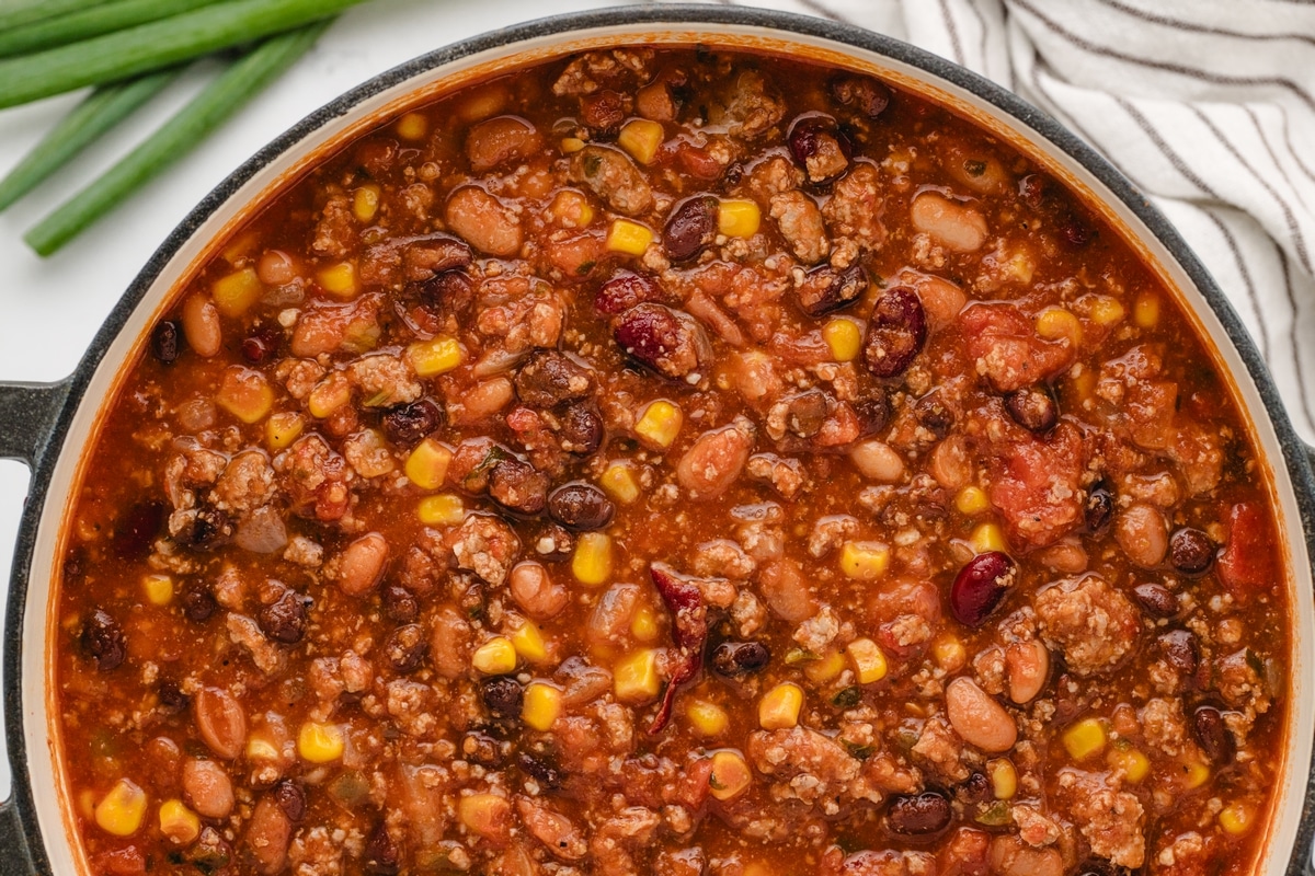 Low Calorie Chili in Pot Dutch oven filled with low calorie chili made with turkey, beans, corn, and tomatoes.
