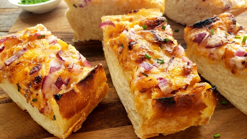 Cheesy Bread Spread will transform your regular loaf of bread into a mouthwatering sensation. Serve this bread with pasta dishes or next to a freshly made salad. #cheesybread