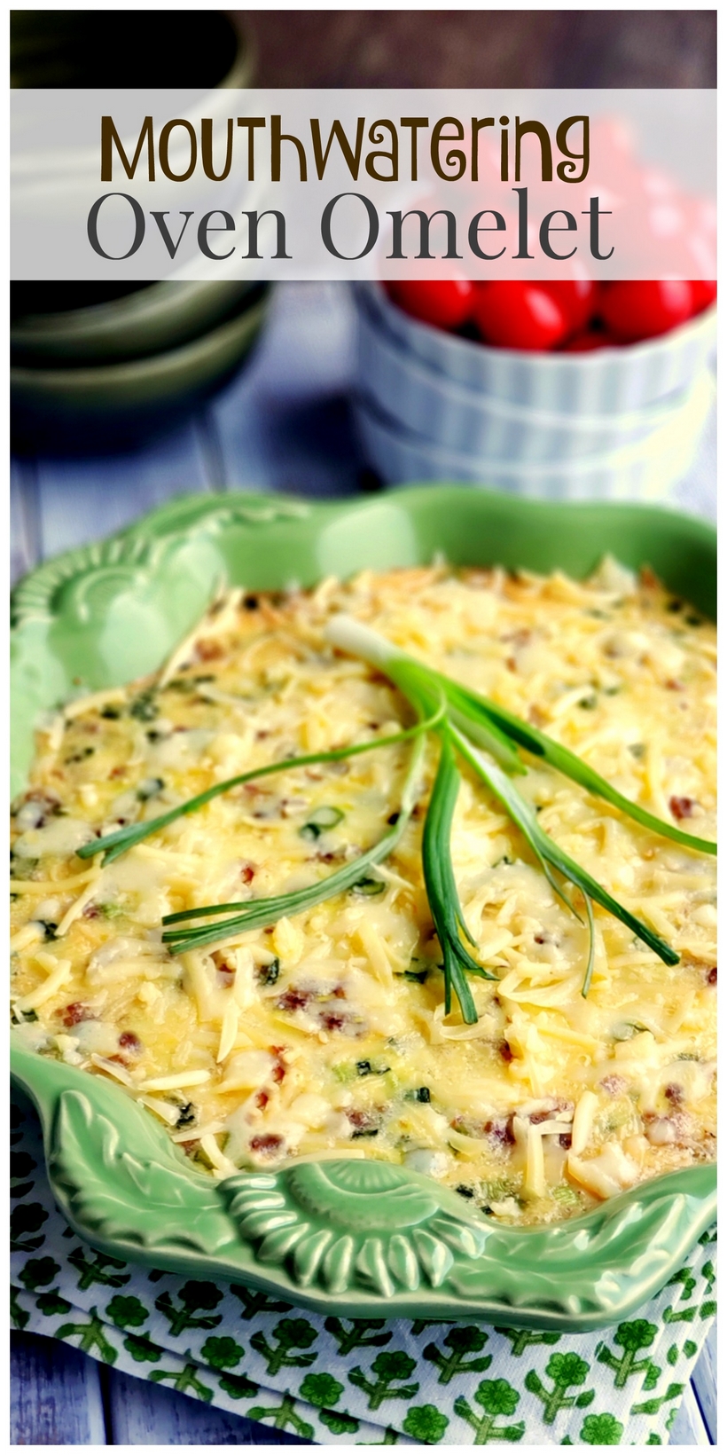 A decadent and sumptuous brunch recipe, this Mouthwatering Oven Omelet will have you wondering why you make eggs any other way. Everyone at your breakfast table will imagine you fussed over this easy omelet, when in reality this egg dish takes very little time to put together. #noblepig #ovenomeletterecipe #ovenomelet #breakfastcasserole #brunchrecipe #bakedomelette #bakedomelet #bruncheggs #bruncheggsforacrowd #bruncheggideas #breakfastfordinner #bruncheggscasserole #brunchideas Text overlay that reads Mouthwatering Oven Omelet with omelet in a green bowl sitting on a printed napkin.